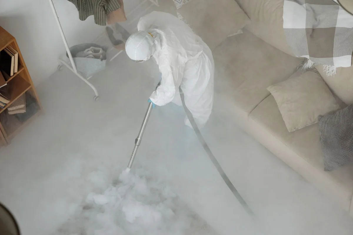 Biohazard cleanup technician in protective equipment, Hays, MT